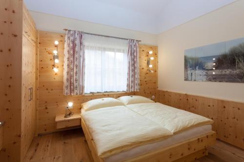 a bedroom with a large bed and a window at Gut Mitterlehen in Elsbethen