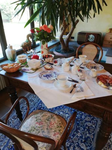 a table with plates of food on it at La Giribaldina Winery & Farmhouse in Calamandrana