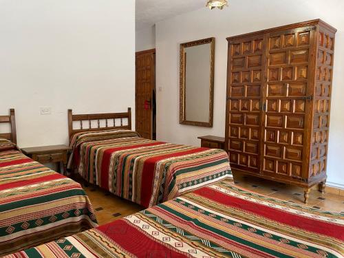 Säng eller sängar i ett rum på Hostal Rural Poqueira