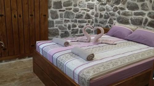 a bed with two pink flamingos on top of it at Apartman Hana in Tivat