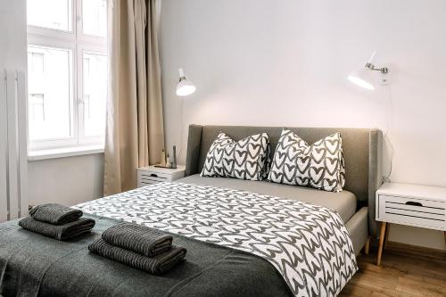 a bedroom with a bed with pillows on it at Nowoczesne 3 pokojowe mieszkanie na Starym Rynku in Toruń