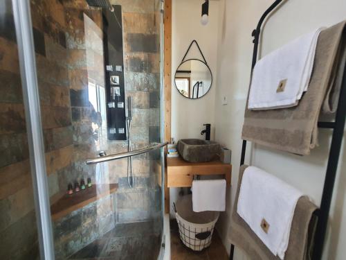 a bathroom with a shower and a sink at Tramonto Luxury Villa No1- Breathtaking sunset view in Karpathos Town