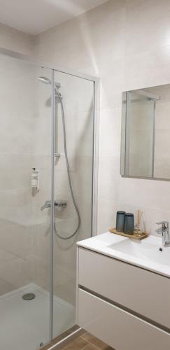 a bathroom with a shower and a sink at Casa do Condado in Vilarinho