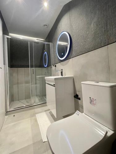 a bathroom with a toilet and a shower and a sink at Agora LX Studios & Suites in Thessaloniki