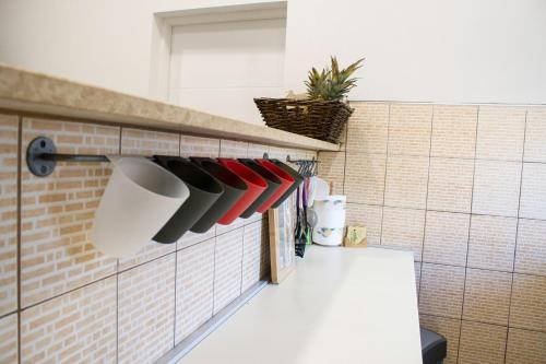 a kitchen with utensils hanging on a wall at White Orchid Pula in Pula
