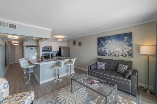 a living room with a couch and a kitchen at 421-Fully renovated, WIFI, Pool, Amazing Views, Near BUCS Stadium in Tampa