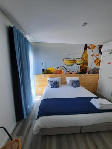 a bedroom with a large bed and a window at Nazaré Sweet Dreams in Nazaré