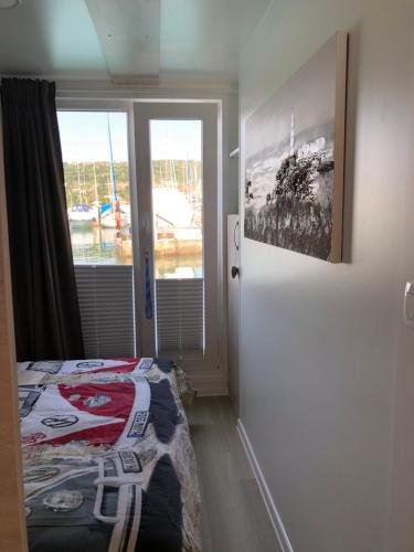 a bedroom with a bed and a door with a window at Nalu Seahouse in Portorož