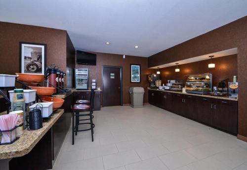 a large kitchen with a counter and a restaurant at Americas Best Value Inn Cuero in Cuero