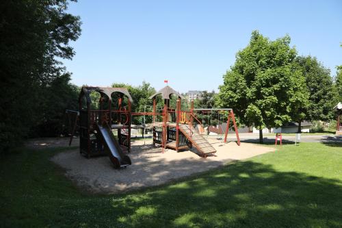 a playground with a slide in a park at Chata Větrník u Černého dolu v Krkonoších in Lauterwasser