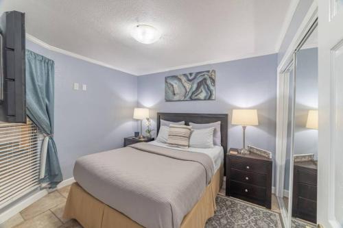 a bedroom with a bed and two lamps and a window at 311-Mermaids condo in Tampa