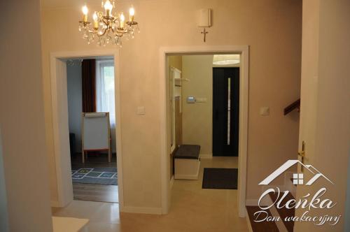 a room with a hallway with a chandelier at Dom Oleńka- Kaszuby, weekend, wakacje, sauna, jacuzzi, jezioro in Garcz