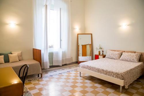 a bedroom with a bed and a mirror and a window at Casa Terracotta in Matera