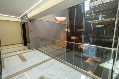 a room with a glass wall and a staircase at Plazza Mamaia Nord in Mamaia Nord