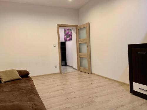 a living room with a couch and a wooden floor at Felicjanek Apartment in Krakow