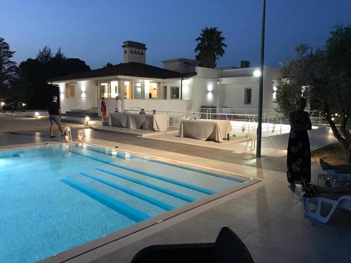 a swimming pool in front of a house at night at Tenuta Bardi in Villa Baldassarri