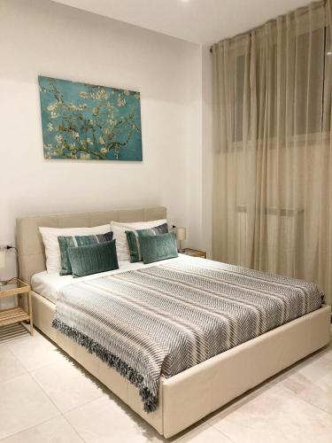a bedroom with a bed and a painting on the wall at Neptune in Francavilla al Mare