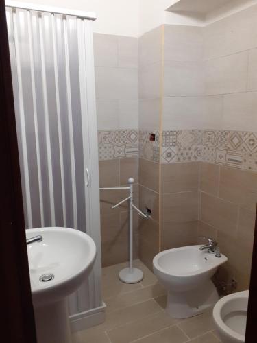 a bathroom with a white toilet and a sink at B&B Casa za CLARA in Aieta
