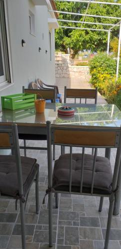 a table and chairs sitting on a patio at Anastasia's garden house in Ialyssos