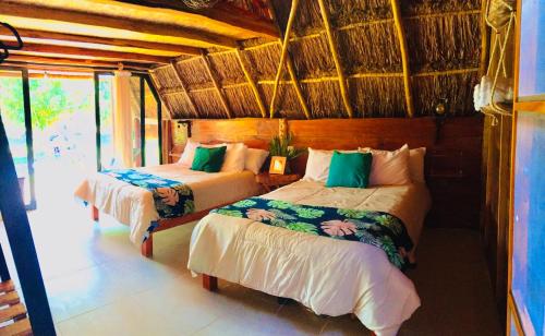 מיטה או מיטות בחדר ב-Mangata Bacalar