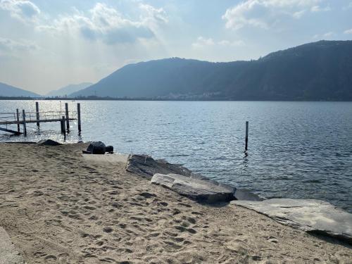 a body of water with a dock on the shore at MIRALAGO -Wonderful Lake view in Bissone