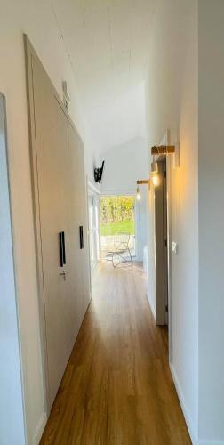 an empty room with a hallway with a hard wood floor at Casa do Patorrinho in Arcos de Valdevez
