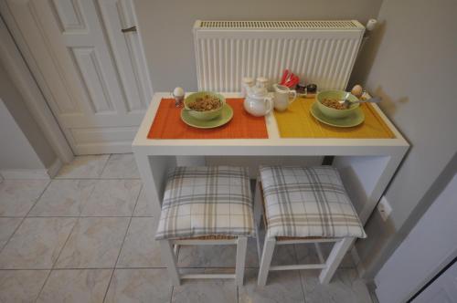 a small table with two plates of food on it at Ariadnes Holiday Accommodation in Apidias Lakos