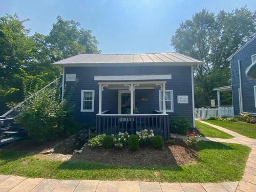 una casa azul con porche y patio en Family Farmhouse Inn en Mount Jackson