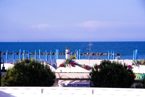 a view of the ocean from a beach with bushes at Casa Portofino Rooms&Breakfast in Cesenatico