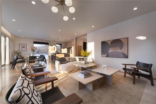 a living room with a couch and tables at Ginto Hirafu by H2 Life in Kutchan