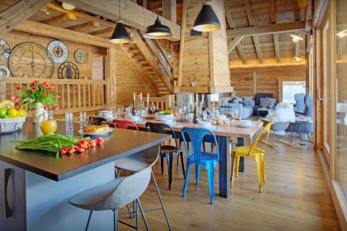a restaurant with tables and chairs in a room at La Ferme du Gran Shan - OVO Network in Les Villards-sur-Thônes