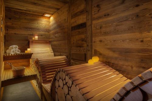 a sauna with a bed in a wooden room at Chalet Alti - OVO Network in Le Grand-Bornand