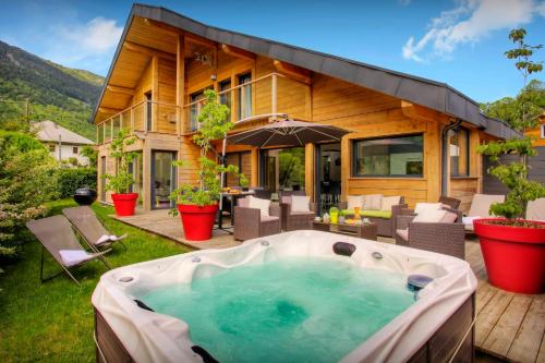 a hot tub in the yard of a house at Chalet de Rollon - OVO Network in Thônes