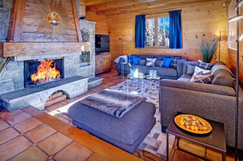 a living room with a couch and a fireplace at La Grange à L'Ours - OVO Network in Manigod