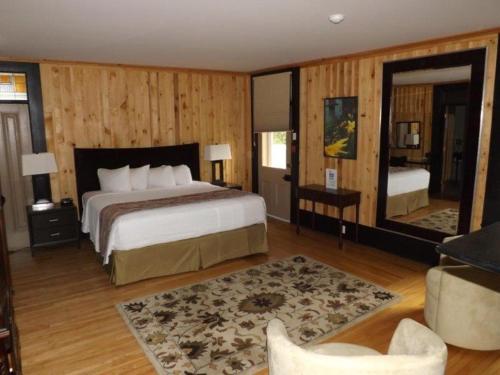 ein Schlafzimmer mit einem großen Bett und einem großen Spiegel in der Unterkunft The White House in Perth