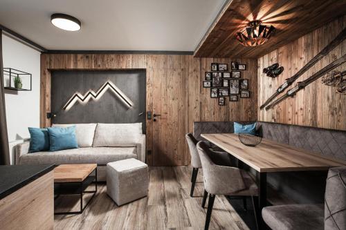ein Wohnzimmer mit einem Sofa und einem Tisch in der Unterkunft Apartments Niederseer in Saalbach-Hinterglemm