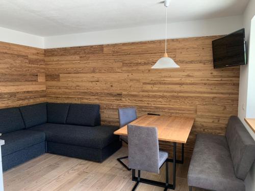 a living room with a couch and a table at Apartment an der Aue in Cadipietra