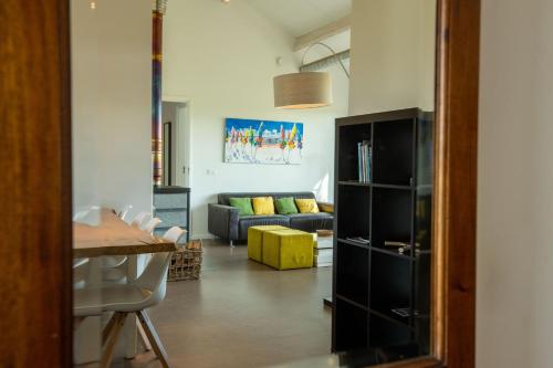 a living room with a couch and a table at Spitsbroek in Eede