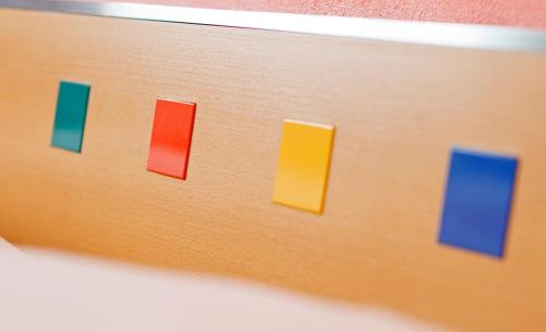 a close up of a remote control with colorful buttons at Hotel Metropol Basel in Basel