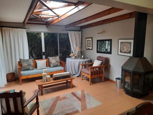 a living room with a couch and a table at Fisant, Bokmakierie and Hoephoep Guest House in Bethlehem