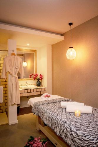 a room with two beds and a bathroom with a mirror at Absolute Sanctuary in Choeng Mon Beach