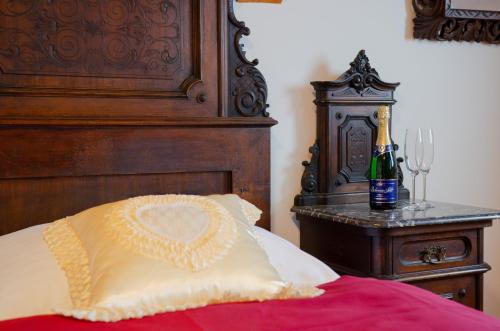 a bed with a bottle of champagne on a table at Chata Emil Zatopek - Maraton - Lysa Hora in Krásná
