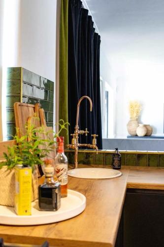 a bathroom counter with a sink and a mirror at Villa Le Roc Kleinmond Accommodation in Kleinmond