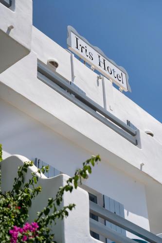 a sign for its hotel on the side of a building at Hotel Iris in Naousa