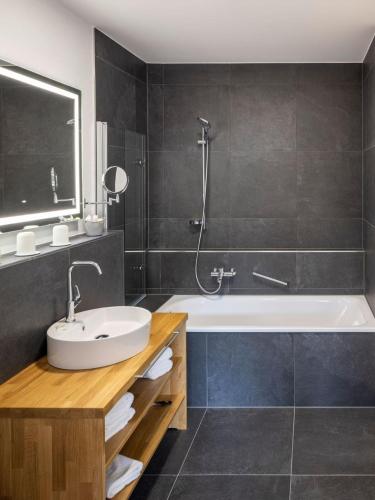 a bathroom with a sink and a bath tub at Bergdorf Spessart in Flörsbachtal