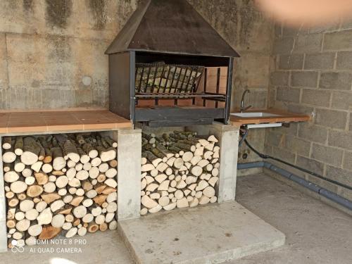 a bird cage filled with logs in a room at Casa "La Huerta" DE RODA DE ISABENA in Roda de Isábena