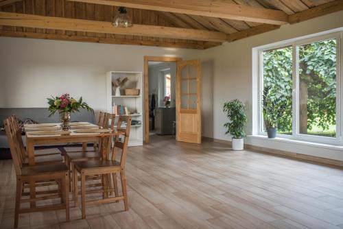 a dining room with a wooden table and chairs at Dizrobeznieki in Veldze