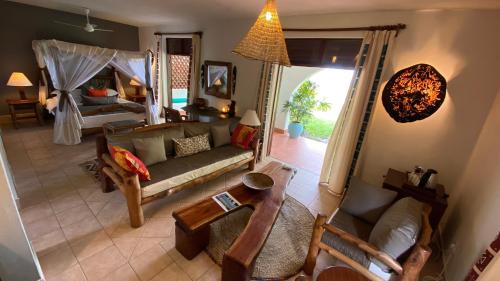 
a living room filled with furniture and a fireplace at Pinewood Beach Resort and Spa in Diani Beach

