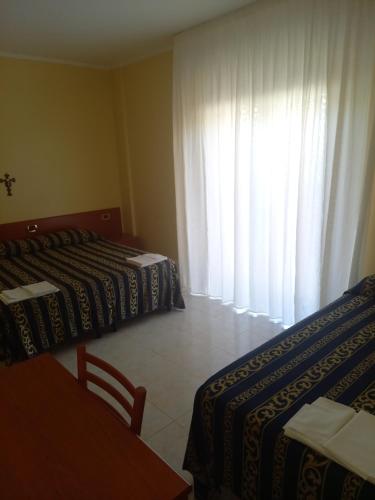 Postel nebo postele na pokoji v ubytování Hotel Il Chierichetto