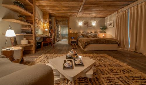 a large room with two beds and a table at Chalet Carte Blanche Katmaï - Val d'Isère in Val-d'Isère